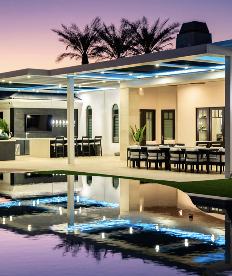 White pergola with recessed puck lighting and color-changing LED lights