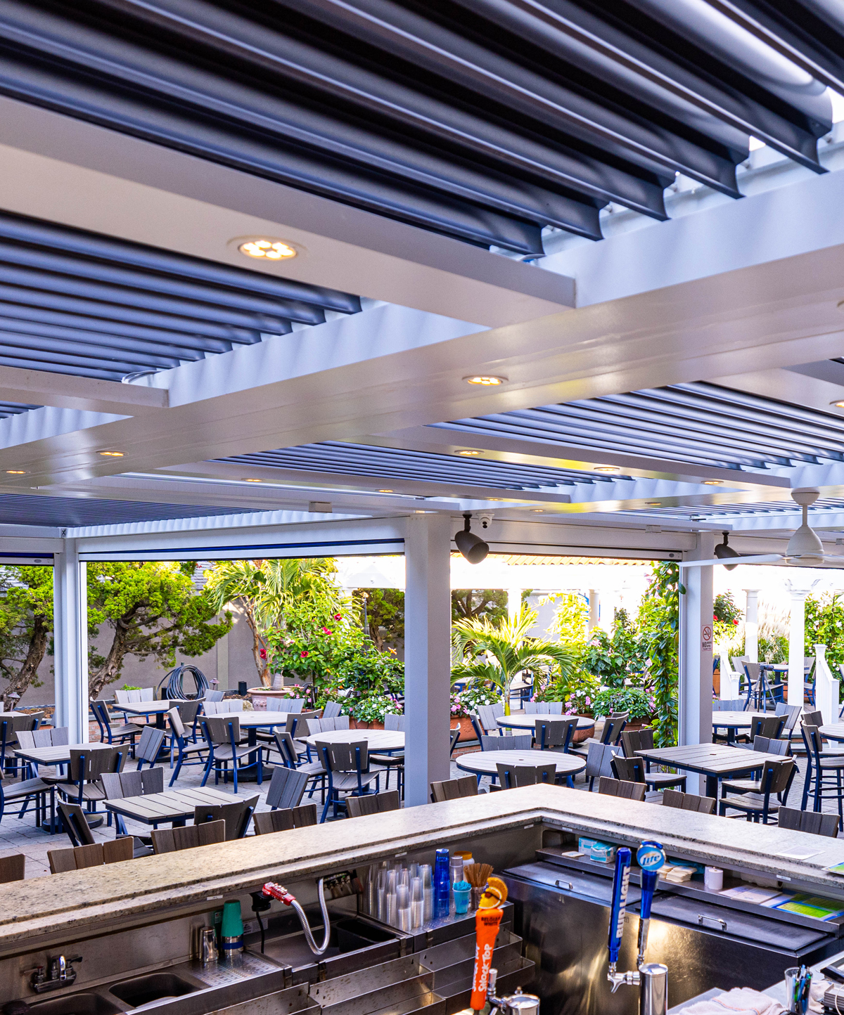 Custom commercial pergola office building Boca Raton StruXure motorized pergola with integrated lighting at a commercial restaurant bar